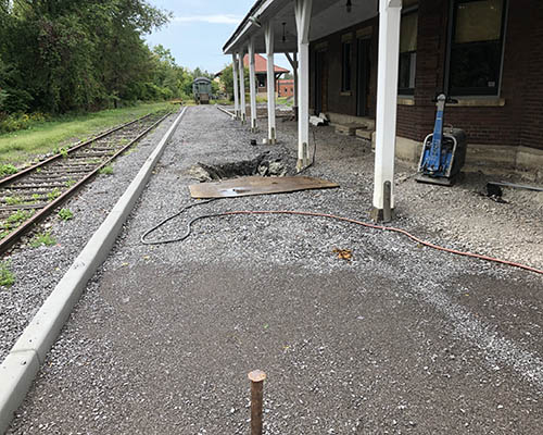 Future brick platform next to railroad tracks