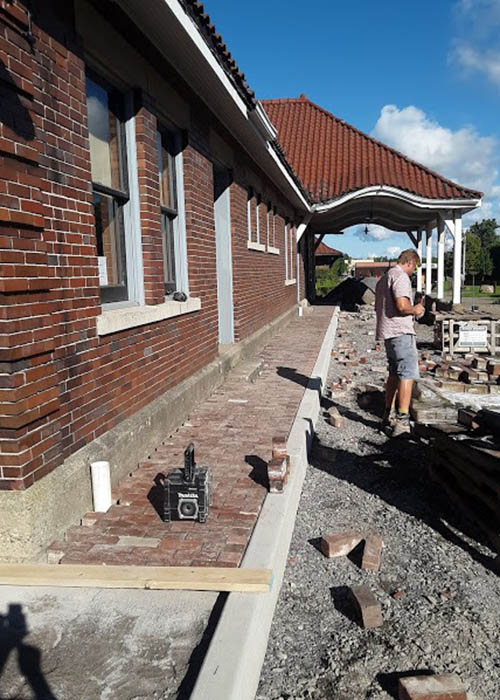 Local labor begins installing historic street brick pavers