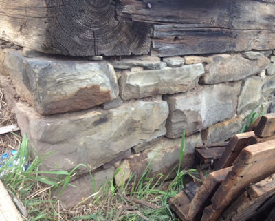Hand cut barn stone under a colonial barn