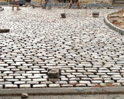 Installation of the used, antique cobblestones is part of the reclaiming experience
