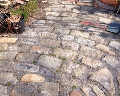 Rustic garden path created by laying antique cobblestones on their side