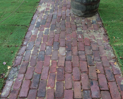 Old street bricks laid on side for sidewalk in historic community