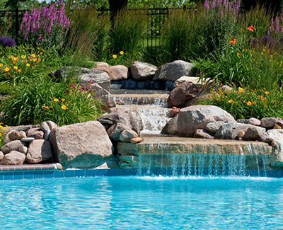 Water garden focal point flows into beautiful pool