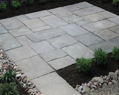 Old stone patio defines the open space in this garden