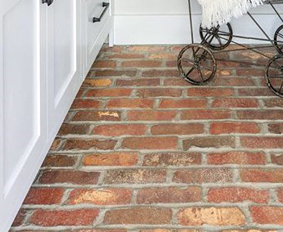 Reclaimed street brick pavers cut to floor tiles for laundry room, installed in a running bond.