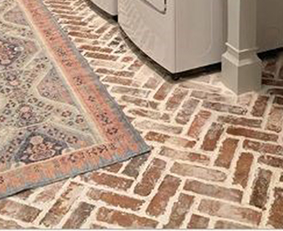 Salvaged brick pavers, cut for floor tiles and installed in a herringbone pattern for a trendy laundry room design.