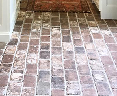 Rustic brick pavers cut to provide antique brick tiles for a kitchen floor.