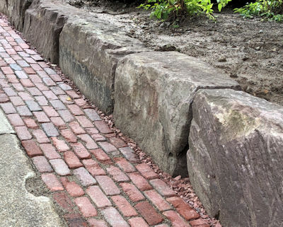 Reclaimed Medina Blocks from the Erie Canal used as a retaining wall