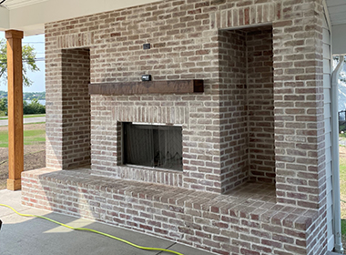 Our Rockpile salvaged thin brick veneer, whitewashed – awesome antique brick outdoor fireplace.