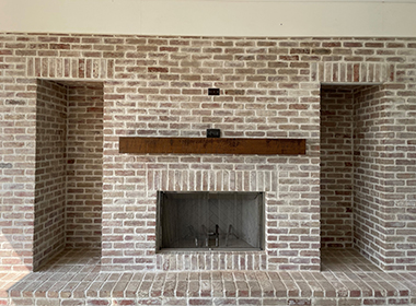 A closer look at the reclaimed brick fireplace, installed using old Rockpile thin brick veneer, whitewashed.